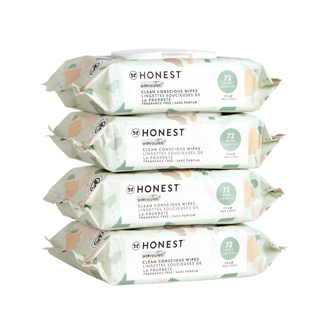 Four packs of The Honest Company Clean Conscious™ Wipes are stacked. Each fragrance-free pack has 72 hypoallergenic wipes suitable for sensitive skin. The light green packaging with abstract shapes displays product details in English and French.