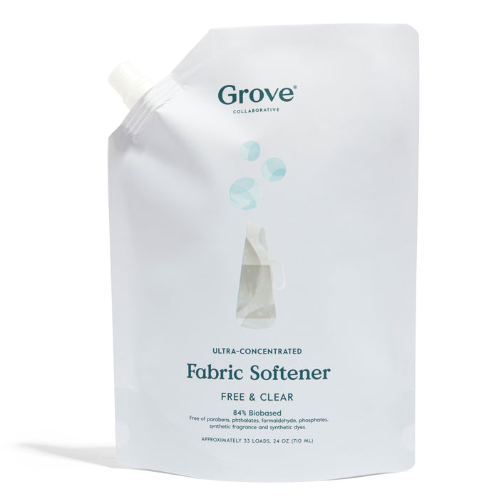 A white pouch of Grove Collaborative Ultra-Concentrated Fabric Softener with a spout. The packaging features minimalist blue and grey graphics and text indicating it is free & clear, 84% biobased, and contains 24 oz.