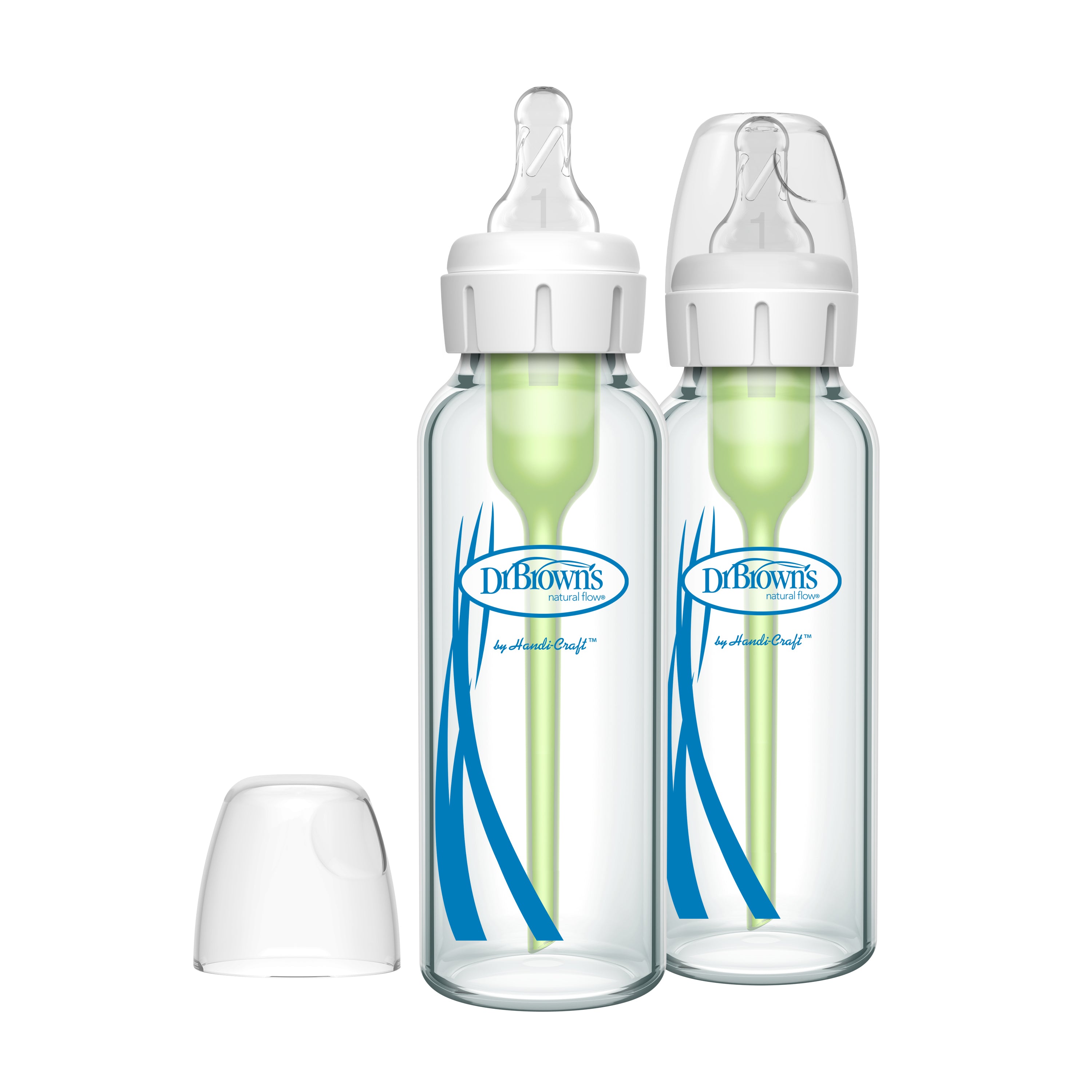 Two transparent Dr. Browns Glass Baby Bottles Natural Flow® Anti-Colic Options+™ showcase a green internal vent system and feature a blue wave design. One bottle has a breast-like nipple while the other with the white cap off, sits beside a separate clear cap.