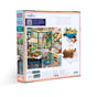 Back of the eeBoo Piece & Love Springtime Kitchen 1000 Piece Jigsaw Puzzle box shows a vibrant kitchen scene with pets, plants, and food, a poem, puzzle piece sample, branding info, and notes on sustainably sourced materials.
