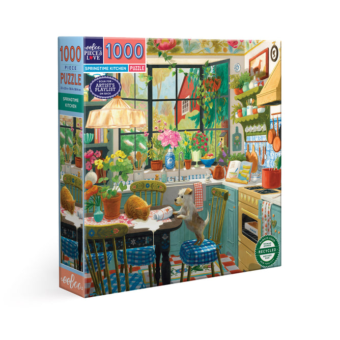 The Springtime Kitchen 1000 Piece Jigsaw Puzzle by eeBoo Piece & Love features a colorful kitchen scene with plants, sunlight, and a dog at a table with yarn balls. Made from sustainably sourced materials and designed with cozy, homey details.
