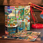 The Springtime Kitchen 1000 Piece Jigsaw Puzzle by eeBoo Piece & Love features a vibrant kitchen scene with cats, plants, and sunlight, made from sustainably sourced materials—perfect for cozy puzzling sessions.
