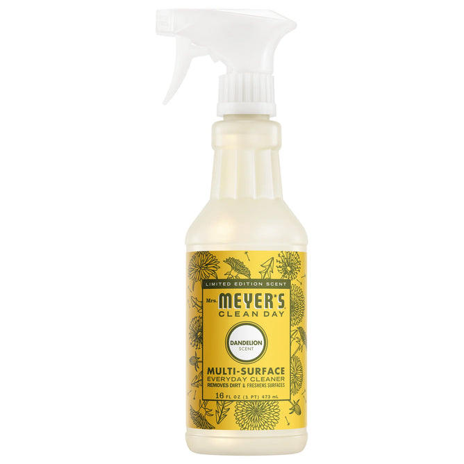 A 16 fl oz bottle of Mrs. Meyer's Multi-Surface Cleaner in limited-edition dandelion scent, with a yellow floral label and white spray nozzle, made with essential oils.