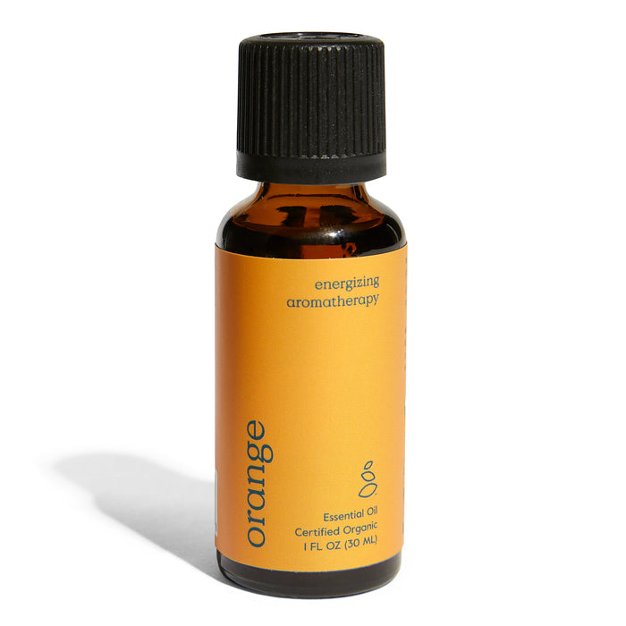 A brown glass bottle with a black cap and an orange label reading orange energizing aromatherapy, Essential Oil, Certified Organic, 1 FL OZ (30 ML). The bottle casts a shadow on a white background.