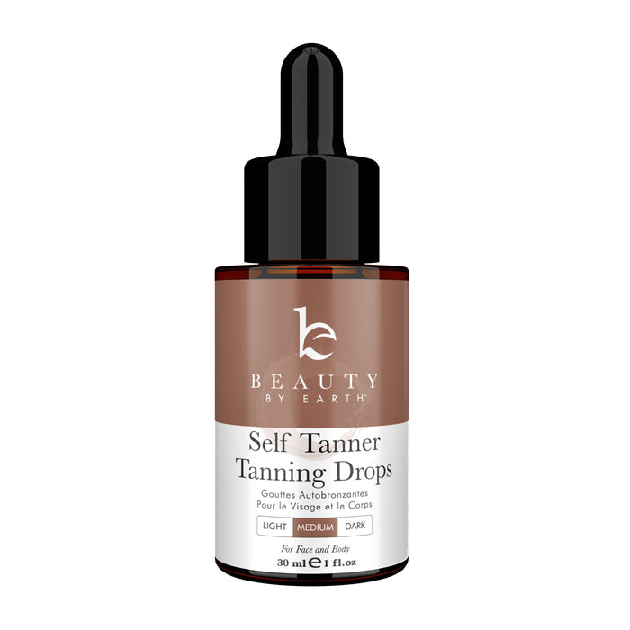 A brown bottle of Beauty by Earth Self Tanner Tanning Drops with a black dropper cap. The label indicates the product is for face and body, offering light, medium, and dark options, in a 30 ml (1 fl oz) size.