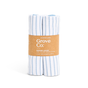 Two Organic Cotton Striped Kitchen Towels from Grove Co., featuring blue and white stripes, come in a brown paper band. Made of 100% organic cotton, they offer quick-drying properties and include details about size and packaging.
