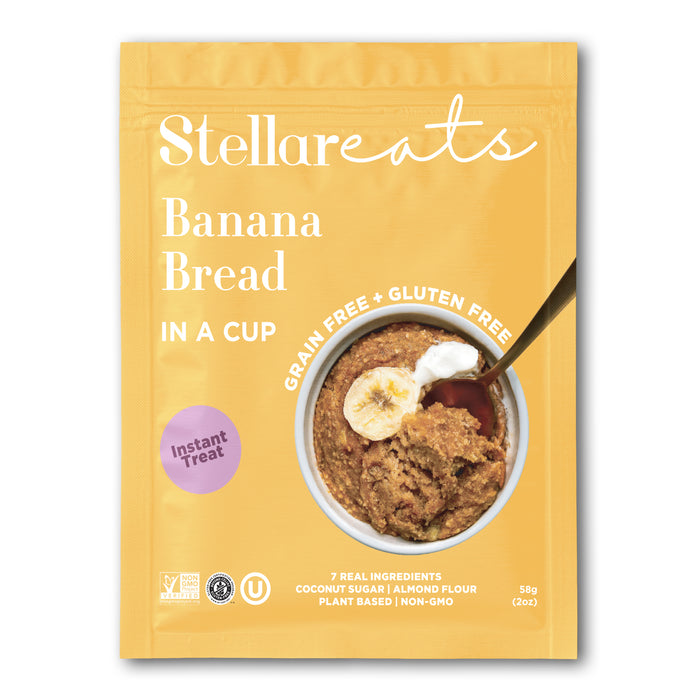 A yellow pouch labeled Stellareats Banana Bread in a Cup, featuring an image of banana bread in a mug topped with banana slices and yogurt. The package is marked grain free, gluten free, and highlights real ingredients.