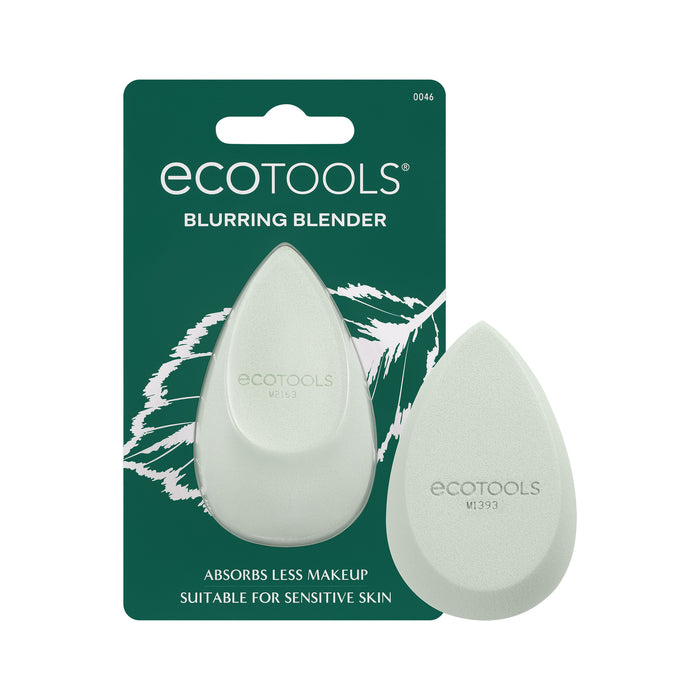 Two pale green, teardrop-shaped makeup sponges are displayed on green Ecotools packaging labeled Blurring Blender. Text states the sponges absorb less makeup and are suitable for sensitive skin.