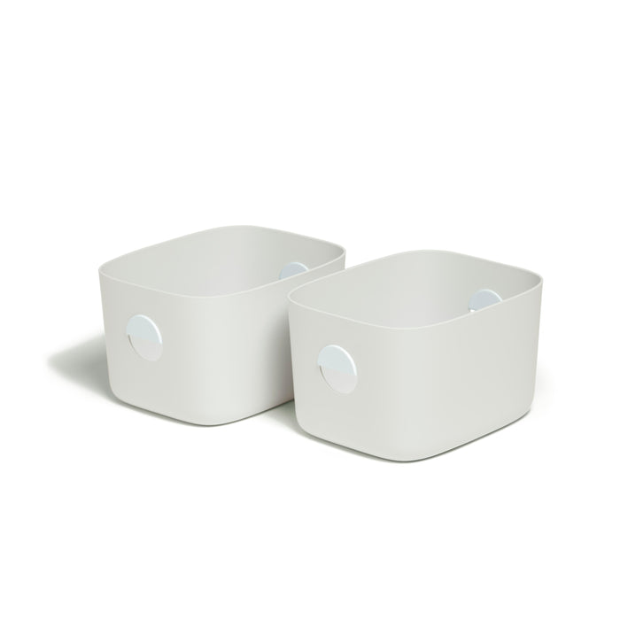 Two rectangular, white plastic storage bins with rounded corners and built-in handles on their sides, placed side by side on a white background.