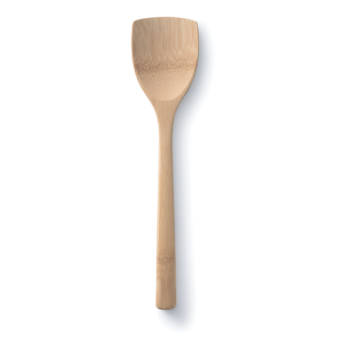 A wooden spatula with a wide, flat head and a smooth handle, shown on a white background with a faint shadow to the right.