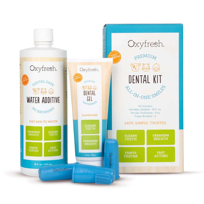 Oxyfresh Premium Dental Kit for pets, including a water additive, dental gel toothpaste, and a box displaying kit details. Packaging highlights benefits like cleaning teeth, fighting tartar, and freshening breath.