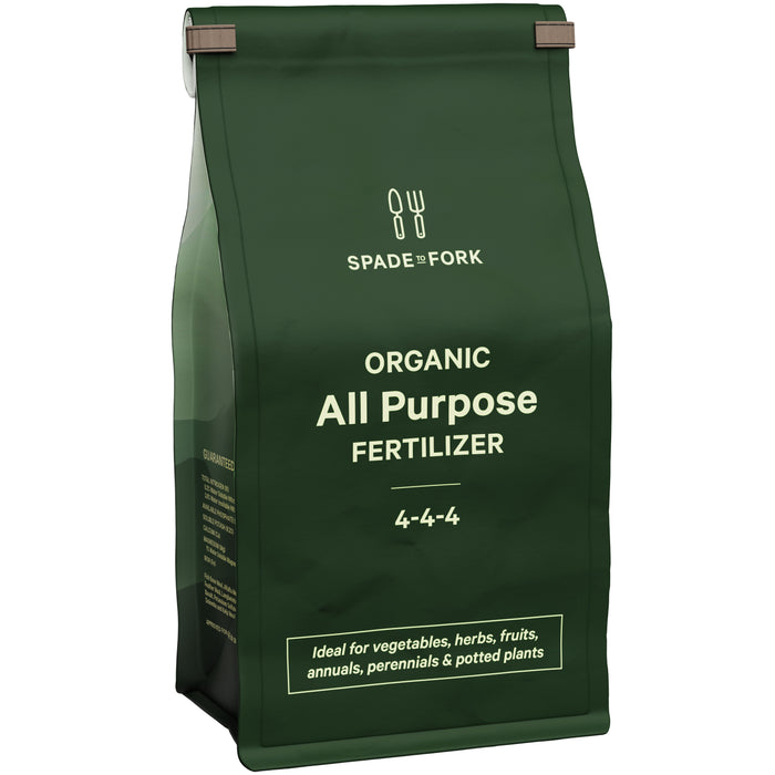 A green bag labeled Spade to Fork Organic All Purpose Fertilizer 4-4-4. Text on the bag mentions it is ideal for vegetables, herbs, fruits, annuals, perennials, and potted plants.