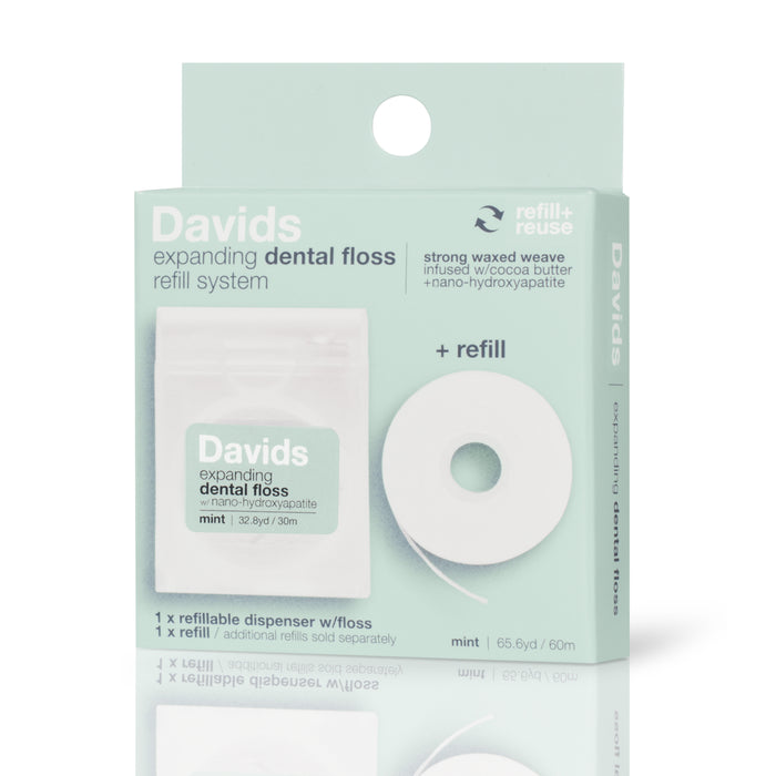 A box of Davids expanding dental floss refill system in mint flavor, showing a refillable dispenser with floss and a separate floss refill. The packaging highlights cocoa butter, nano-hydroxyapatite, and a 65.6-yard length.