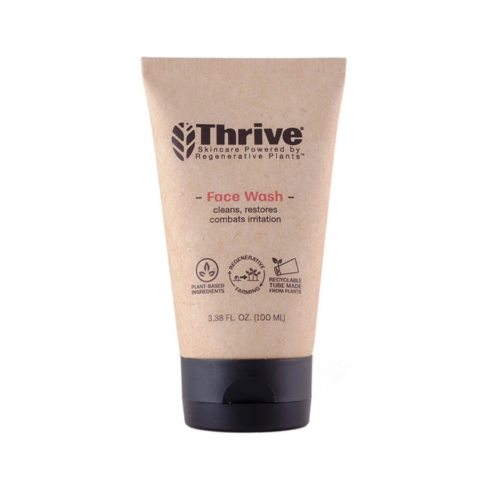 A tube of Thrive Face Wash with a brown, eco-friendly label that highlights plant-based ingredients, regenerative plants, recyclable packaging, and a size of 3.38 fl oz (100 ml).