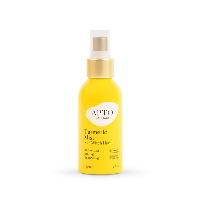 A yellow bottle of APTO Skincare Turmeric Mist with Witch Hazel featuring a gold spray cap and white label. The text describes it as refreshing, cooling, and invigorating, and the bottle contains 120 ml (4 fl oz).