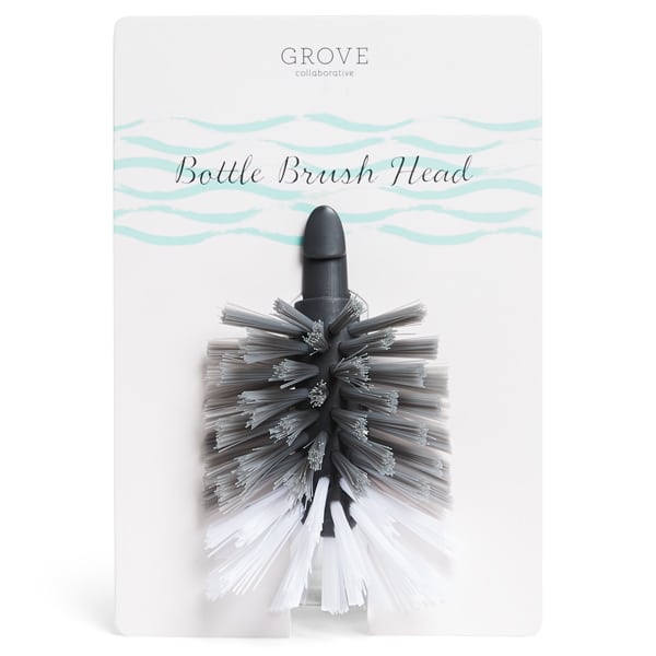 A replacement bottle brush head with gray and white bristles is attached to Grove Collaborative packaging labeled Bottle Brush Head.