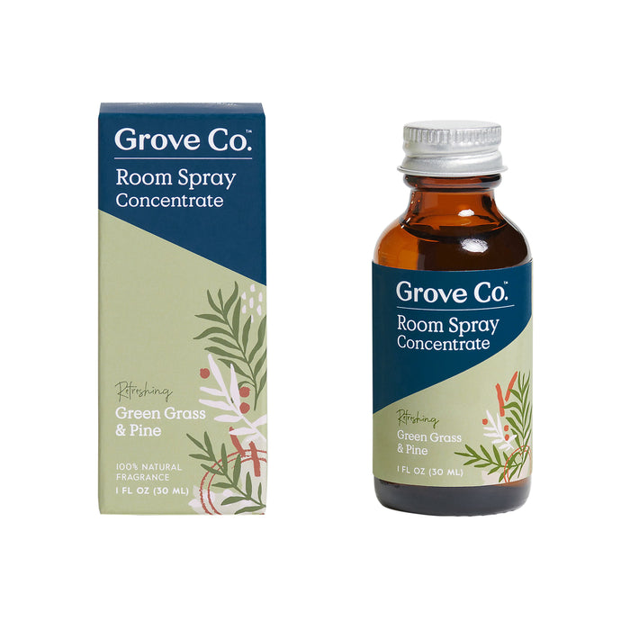 Grove Co. Room Spray Concentrate features a Refreshing Green Grass & Pine scent, crafted from natural fragrances and essential oils. The product comes in an amber bottle with a silver cap and packaging decorated with green leaves and white flowers for a nature-inspired look.