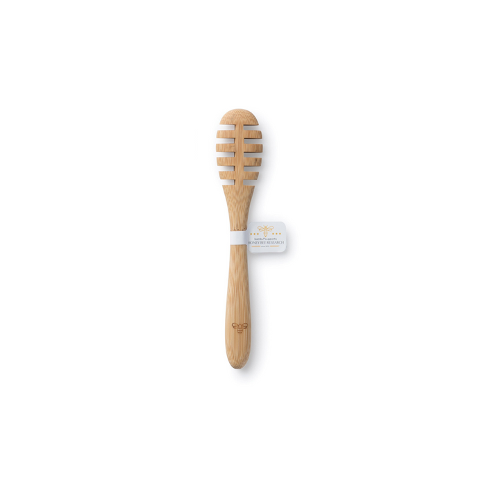 A wooden honey dipper with grooves, featuring a branded tag wrapped around the handle, displayed on a white background.