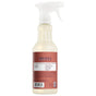 A spray bottle of Mrs. Meyer’s Multi-Surface Cleaner with a white trigger and brown label showing details and ingredients; essential oils featured on the back.