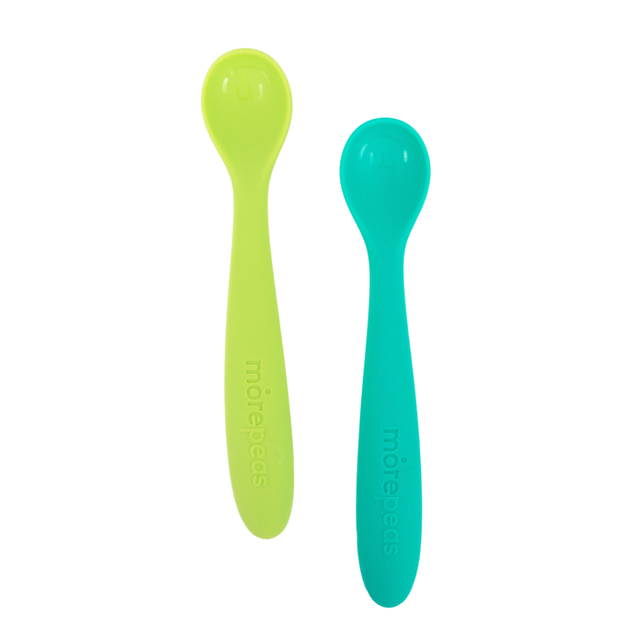 Two plastic baby spoons, one light green and one teal, with rounded tips and the word mürebébes embossed on their handles, placed side by side on a white background.