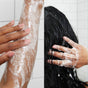 Close-up of a person washing their arm with soapy bubbles on the left, and another close-up of a person washing their wet hair with lather in a tiled shower on the right.