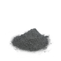 A small mound of fine, dark gray powder—Chagrin Valley Soap & Salve’s Activated Charcoal Clay Face Mask—is spread on a white surface and centered against a plain white background.