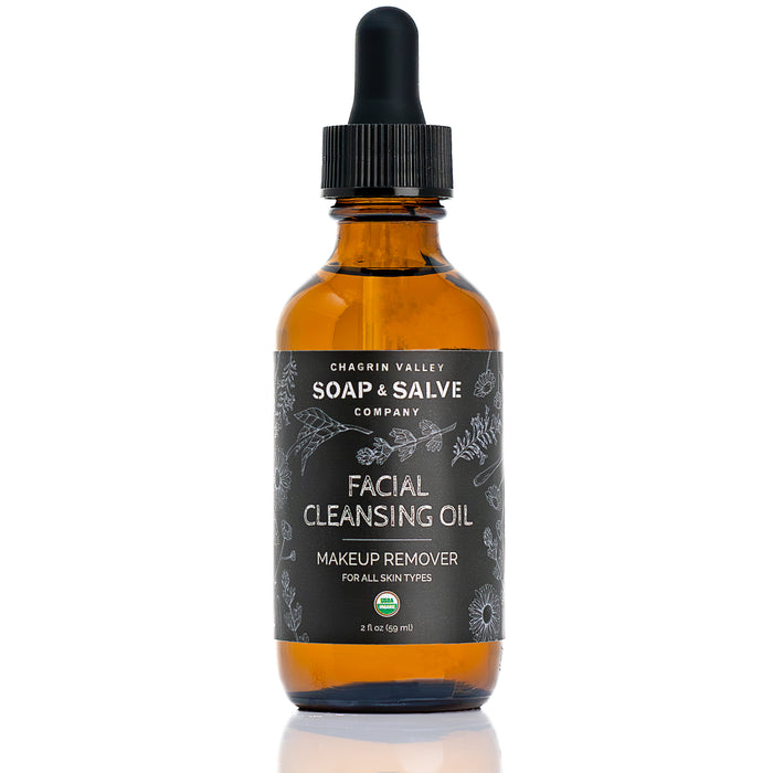 A brown glass dropper bottle labeled Chagrin Valley Soap & Salve Facial Cleansing Oil Makeup Remover, with a black dropper cap and botanical sketches; gentle, non-comedogenic, and suitable for all skin types.