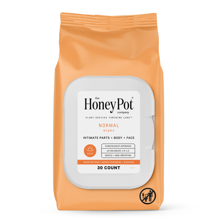 A package of The Honey Pot Company Normal Wipes for intimate parts, body, and face. The orange and white pack contains 30 wipes and is labeled as plant-derived, gentle, non-irritating, and gynecologist-approved.