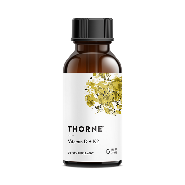 A brown glass bottle with a black cap labeled Thorne Vitamin D + K2. The white label features an abstract yellow botanical design. The bottle contains 1 fl oz (30 ml) of dietary supplement.