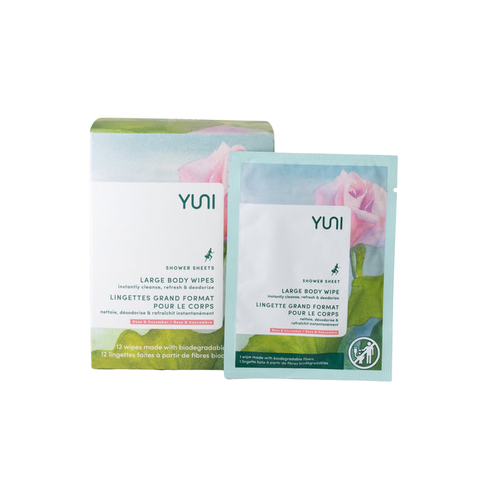 A box and a single packet of Yuni Shower Sheets Large Body Wipes. The packaging features floral artwork and green accents, with text in English and French describing the product as biodegradable and for body use.