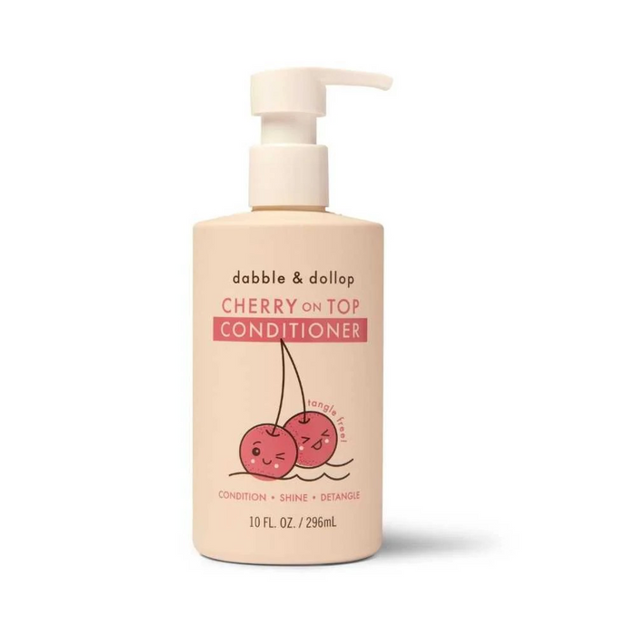 A beige pump bottle labeled Dabble & Dollop Cherry on Top Conditioner features two smiling cherries. The text highlights benefits: condition, shine, detangle. The bottle size is 10 fl. oz. (296 mL).