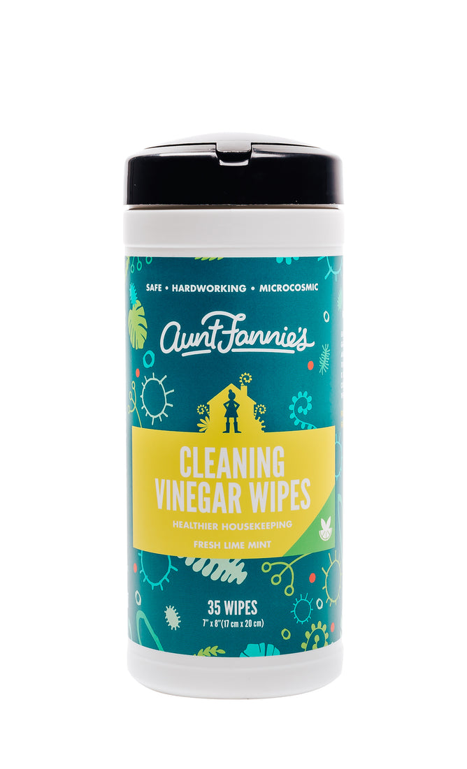 Aunt Fannies Cleaning Vinegar Wipes come in a cylindrical container with a teal label and yellow text. The Fresh Lime Mint scent is featured, along with bubble and germ designs. These natural wipes are effective yet gentle, offering 35 wipes per container.