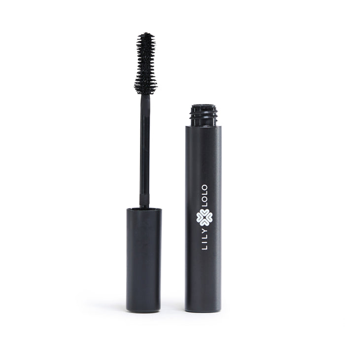 A black tube of Lily Lolo mascara with the wand applicator removed and standing upright beside the tube, showing the bristled brush and the brand logo on the tube.