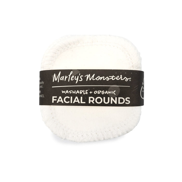 A stack of white, reusable facial rounds wrapped in a black label that reads “Marley’s Monsters Washable + Organic Facial Rounds.”.