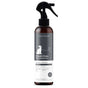 A bottle of kin+kind Charcoal Odor Neutralizer spray for dogs, featuring a black and white label with a dog illustration and a spray nozzle on top. The product is natural, organic, and suitable for pets.