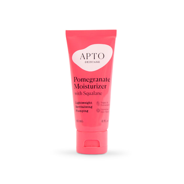 A bright pink tube of APTO Skincare Pomegranate Moisturizer with Squalane, featuring product details and benefits in white and red text on the front. The tube contains 60 ml (2 fl oz) of moisturizer.