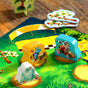 Race colorful animal-shaped game pieces—blue owl, red panda, white bird—across the vibrant Bamboo Rally Cup: Hype in the Jungle board by HABA. Features yellow and green checkered flags and a lively racetrack. For ages 6+.