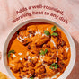 A bowl of orange creamy curry garnished with cilantro sits on a table. The text above reads, Diaspora Spice Co. Garam Masala adds a well-rounded, warming heat to any dish with carefully blended South Asian spices.