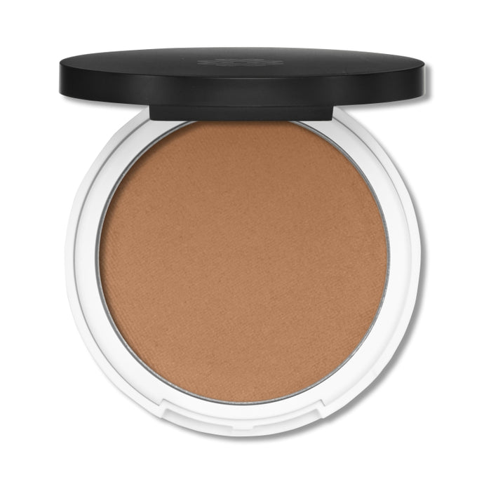 An open compact of matte pressed powder makeup with a light brown shade, featuring a white base and a black lid.