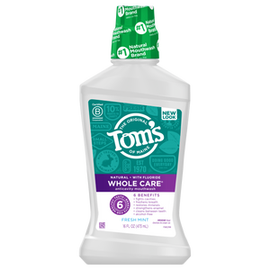 Toms of Maine Whole Care Anticavity Mouthwash offers 16 fl oz (473 mL) of alcohol-free freshness, featuring six benefits, fresh mint, and natural ingredients, as highlighted on its purple and white label.