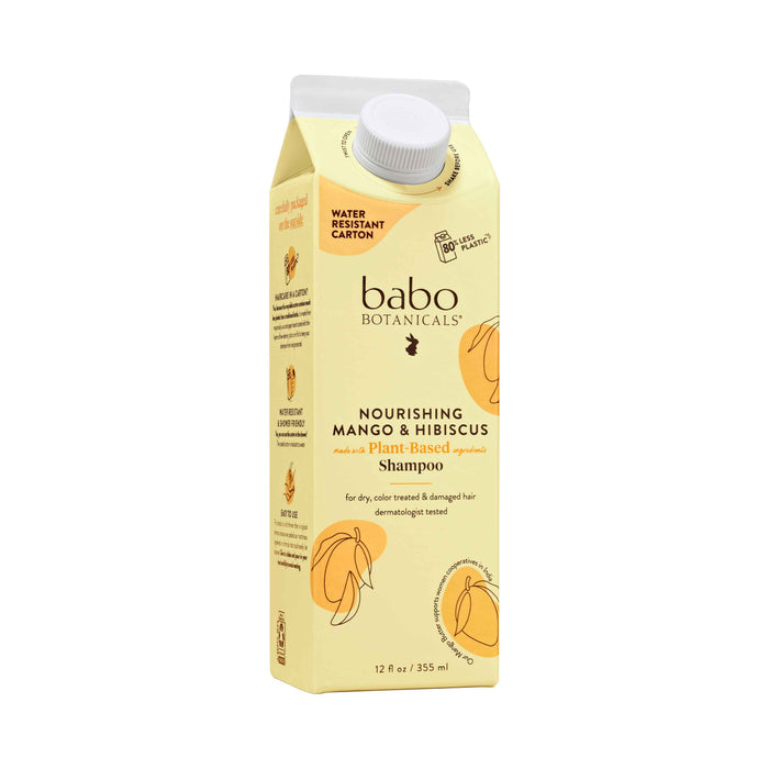 A yellow carton of Babo Botanicals Nourishing Mango & Hibiscus Plant-Based Shampoo, 12 oz size, featuring a water resistant carton, illustrated mango and hibiscus, and text for dry, color-treated, and damaged hair.