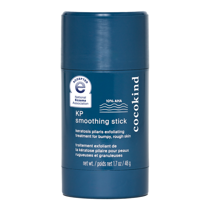 A blue cylindrical container of Cocokind KP Smoothing Stick with 10% AHA, labeled for keratosis pilaris exfoliating treatment for bumpy, rough skin; 1.7 oz size with product details printed in white.