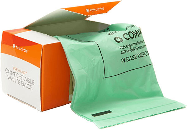 A partially opened orange and white box labeled Compostable Waste Bags with a roll of green compostable bags partially pulled out.