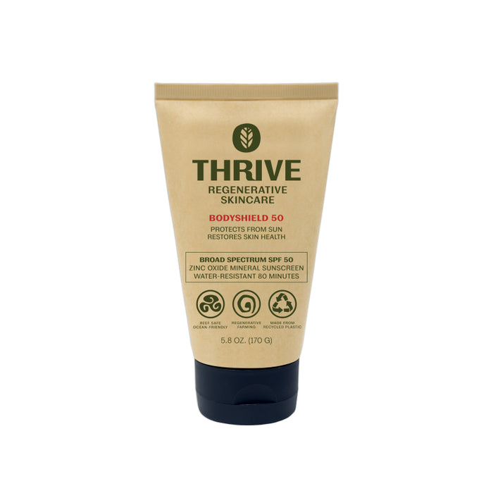 A tan tube of Thrive Regenerative Skincare Bodyshield 50 mineral sunscreen with SPF 50, standing upright. The label highlights broad spectrum protection, zinc oxide, and water resistance for 80 minutes.