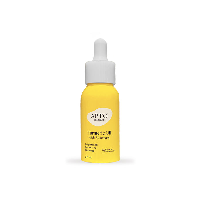 A yellow dropper bottle labeled APTO Skincare Turmeric Oil with Rosemary with a white cap, featuring text about its brightening, nourishing, and prepping benefits, on a white background.