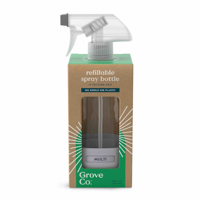 A Grove Co. refillable spray bottle in polished gray is shown inside a cardboard box with a cutout, displaying the bottle. The packaging highlights No single use plastic and MULTI on the bottle label.