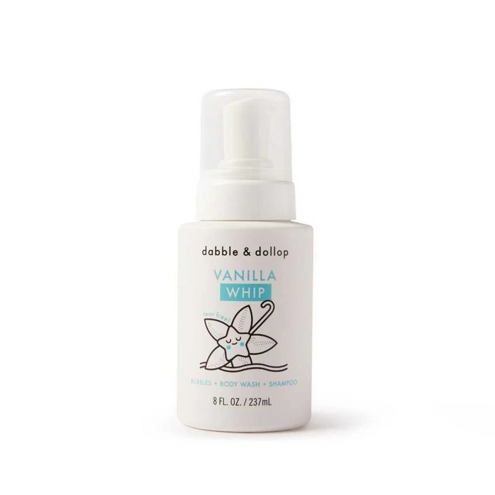 A white bottle of Dabble & Dollop Vanilla Whip with a pump dispenser. The label features a smiling cartoon vanilla flower and text indicating it is a 3-in-1 bubbles, body wash, and shampoo, 8 fl. oz. (237 mL).
