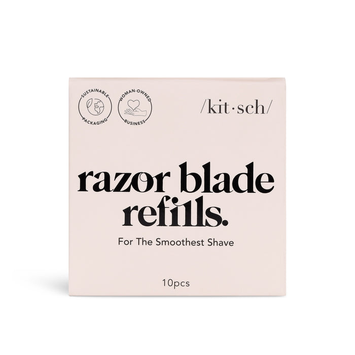A pink box labeled razor blade refills with black text, featuring logos for sustainable packaging and woman-owned business, and the brand name kit•sch. The box contains 10 razor blade refills.