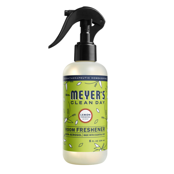 A bottle of Mrs. Meyer’s Clean Day Room Freshener in Lemon Verbena scent, featuring a spray nozzle and a green label with leaves and text, standing upright on a white background.