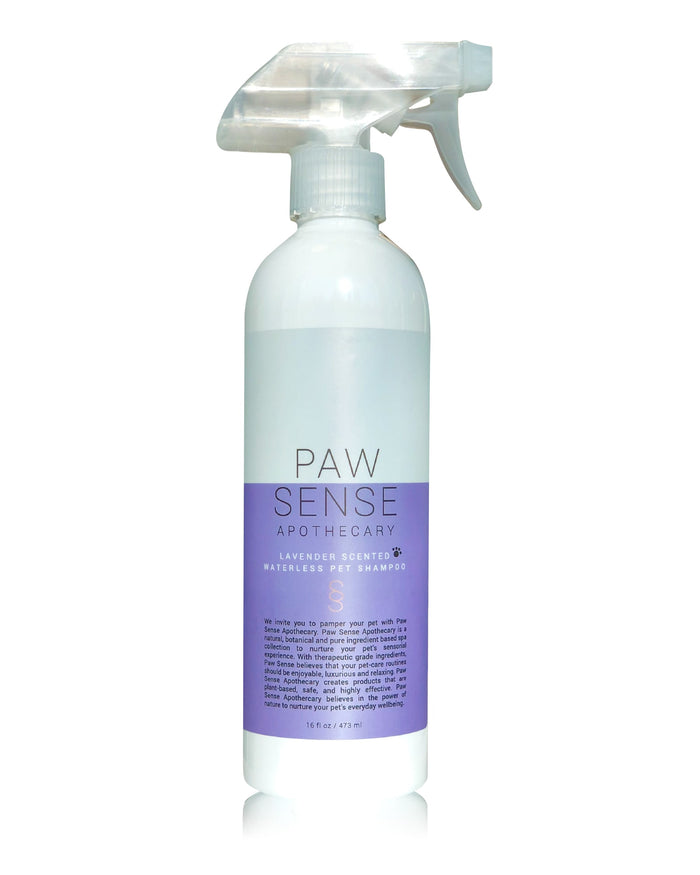 A white spray bottle labeled Paw Sense Apothecary Lavender Scented Waterless Pet Shampoo with a purple label, against a white background.